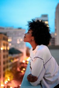 Black woman overlooking the city.